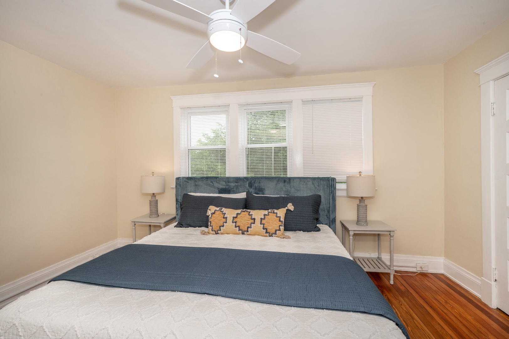 The 1st of 3 bedrooms offers a king bed & ceiling fan