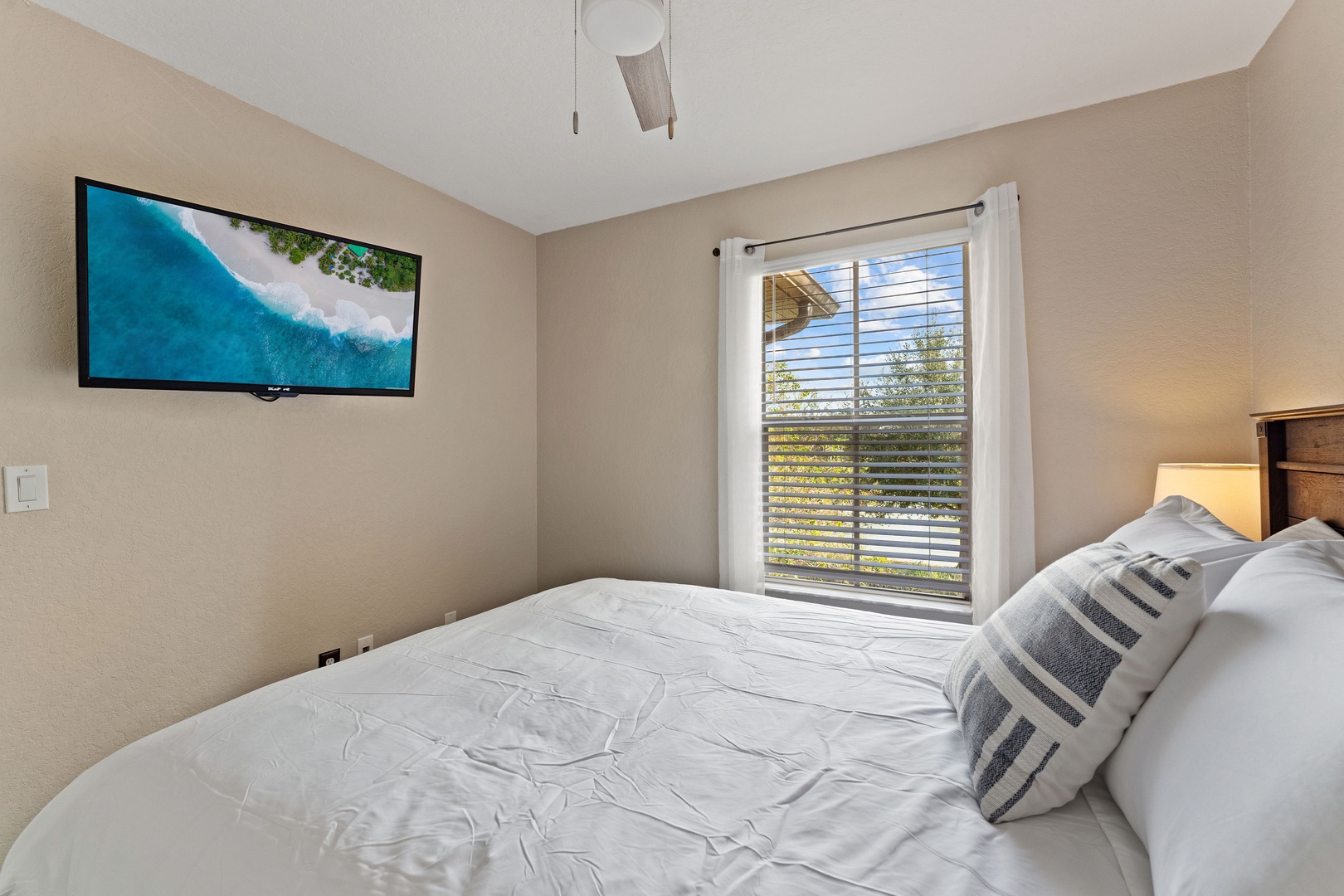 This 2nd floor queen bedroom includes a TV & ceiling fan