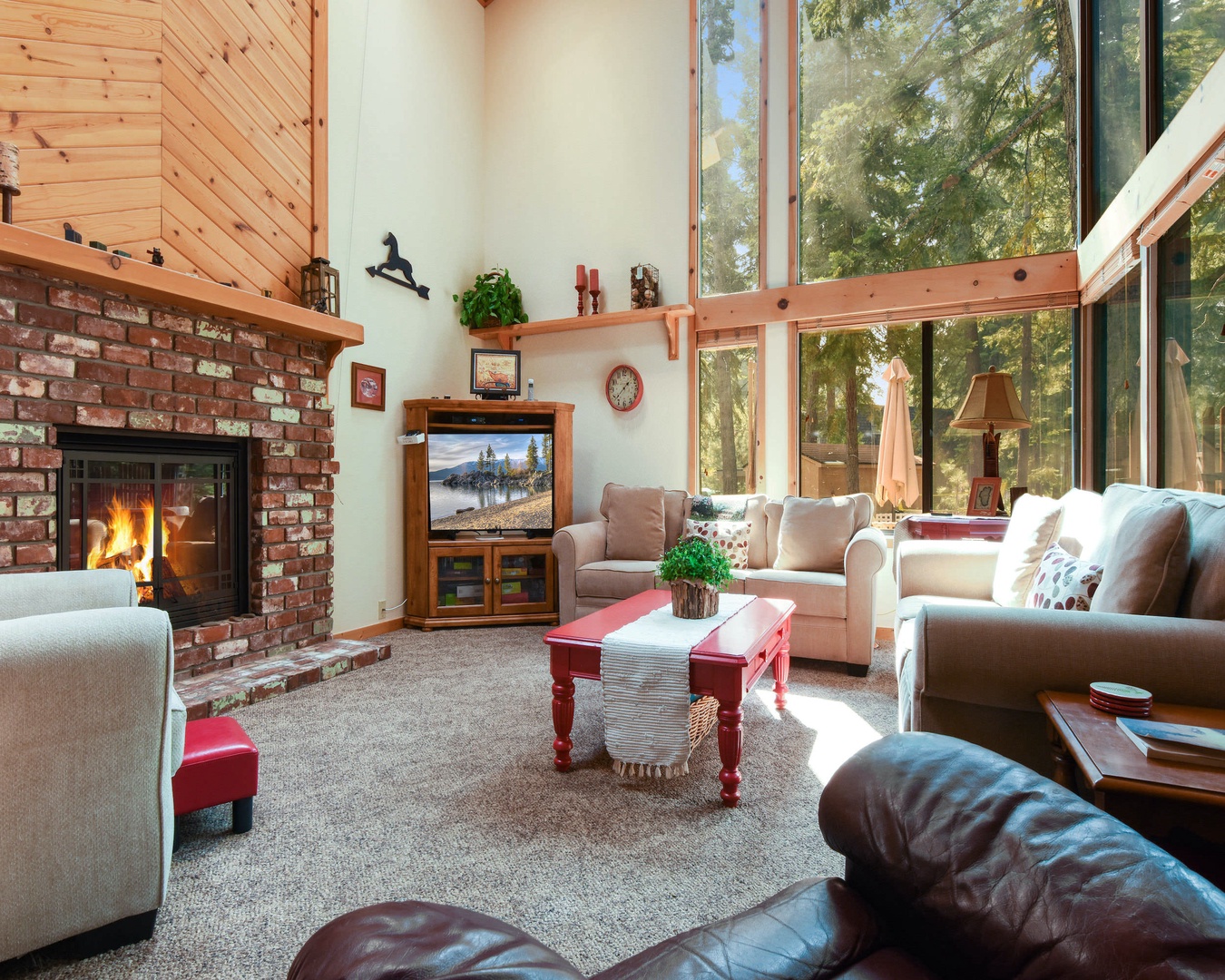 Living room with floor to ceiling windows, gas fireplace, RokuTV