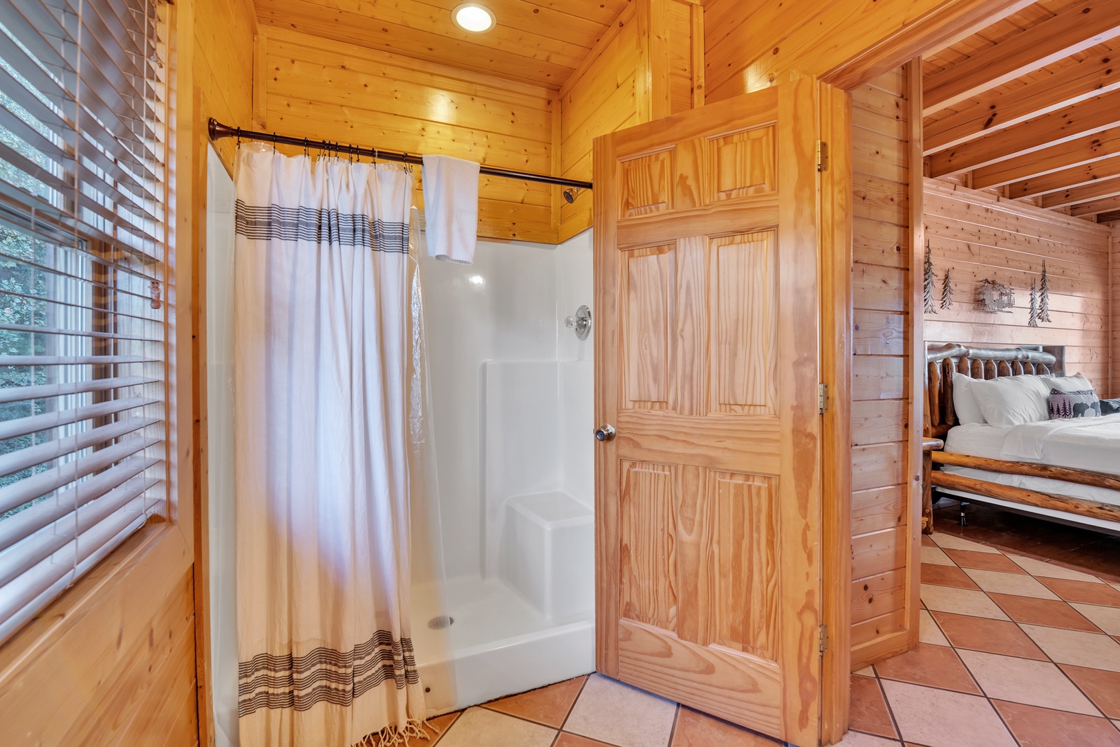 This 3rd floor en suite bath offers a single vanity & walk-in shower