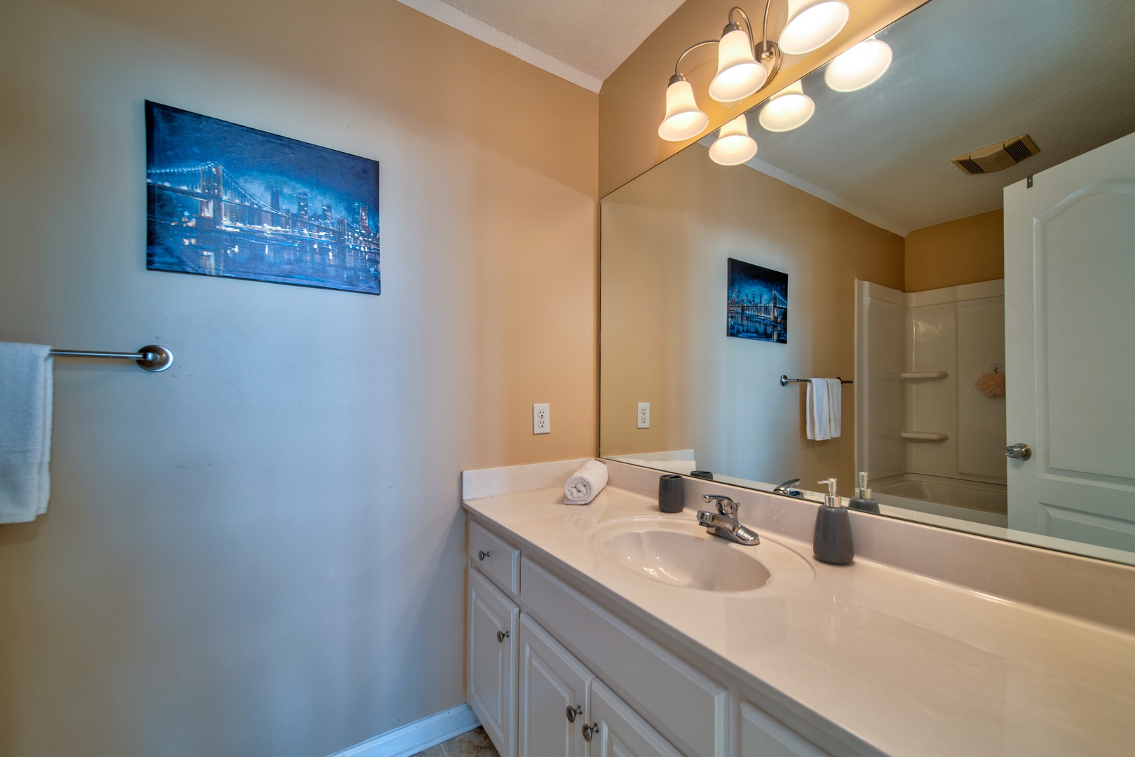 This 2nd floor full bathroom includes a large vanity & shower/tub combo