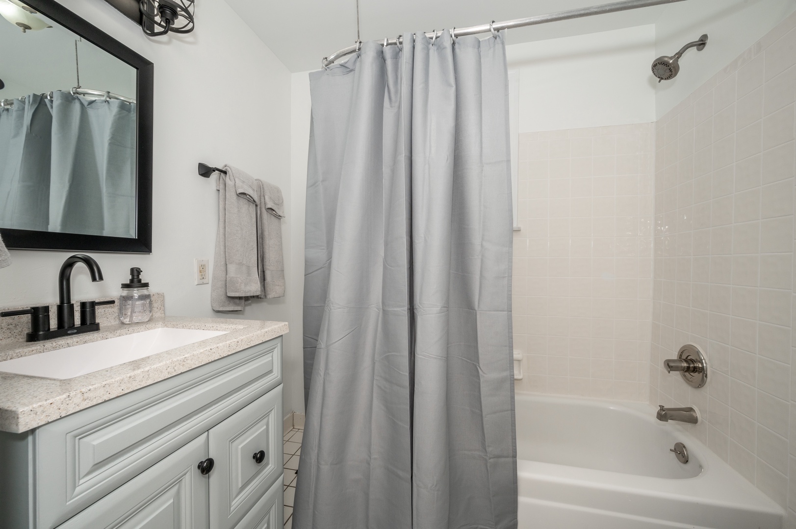Unit 1 – The full bathroom includes a single vanity & shower/tub combo