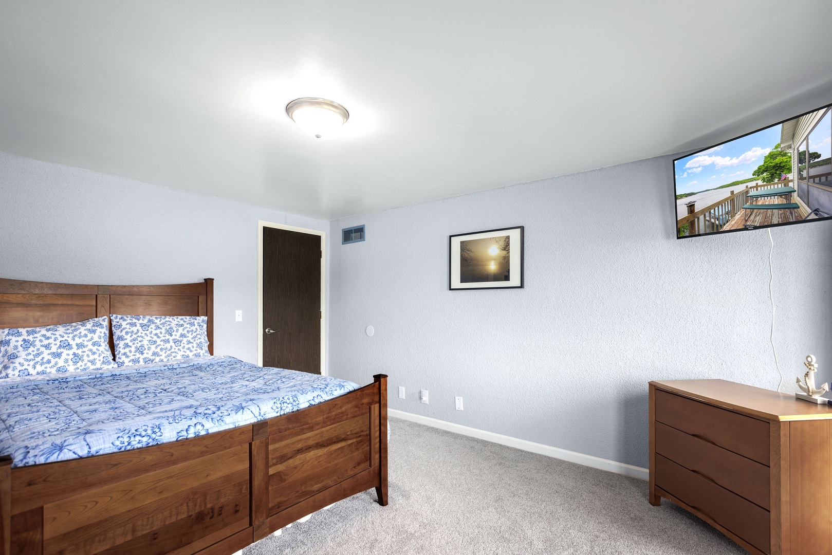 A queen bed & Smart TV is available in this lower-level bedroom