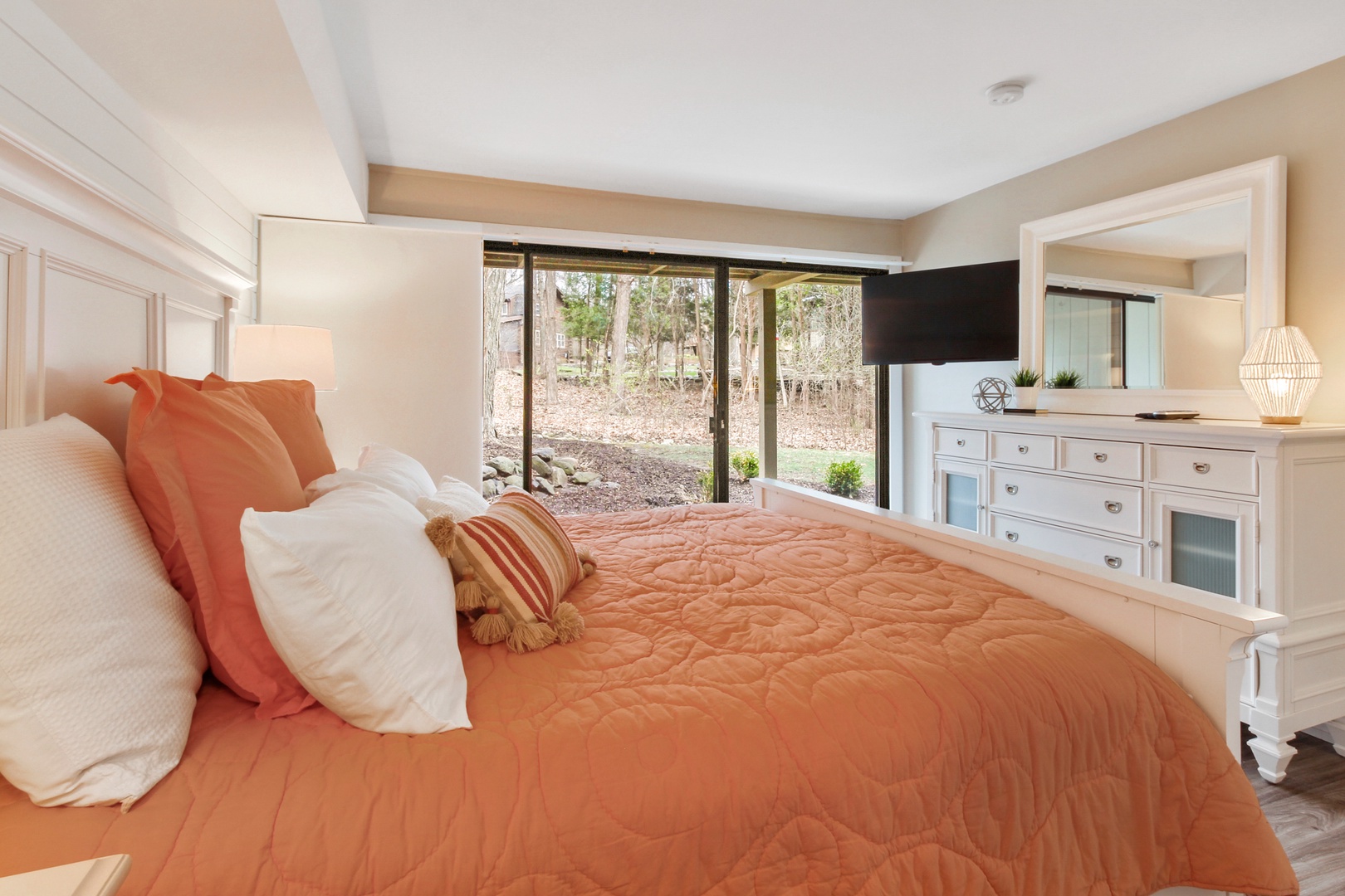 This bedroom sanctuary features a luxurious king-sized bed and deck access.