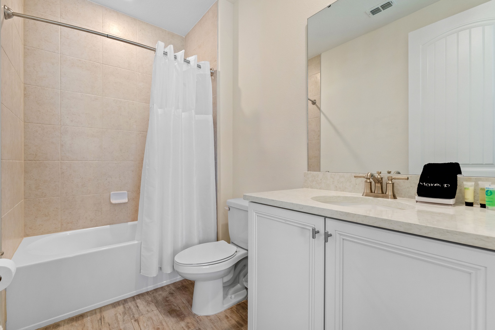 Wash up in this ensuite, featuring a single vanity & shower/tub combo