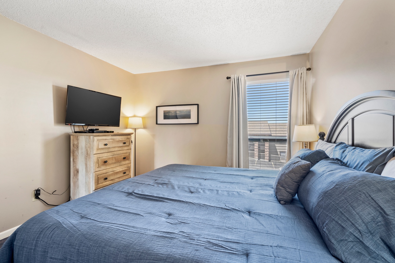 Unit 19’s tranquil primary suite boasts a plush king bed, ensuite, & TV