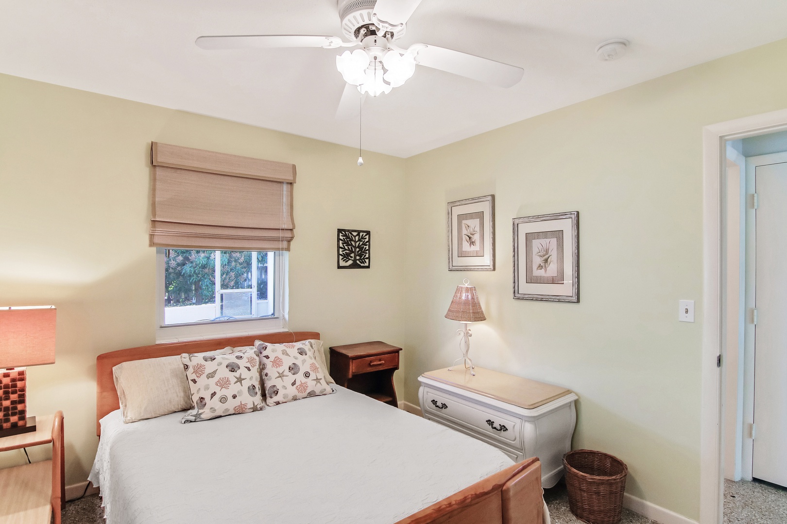 The first of two additional bedrooms, showcasing a plush queen-sized bed