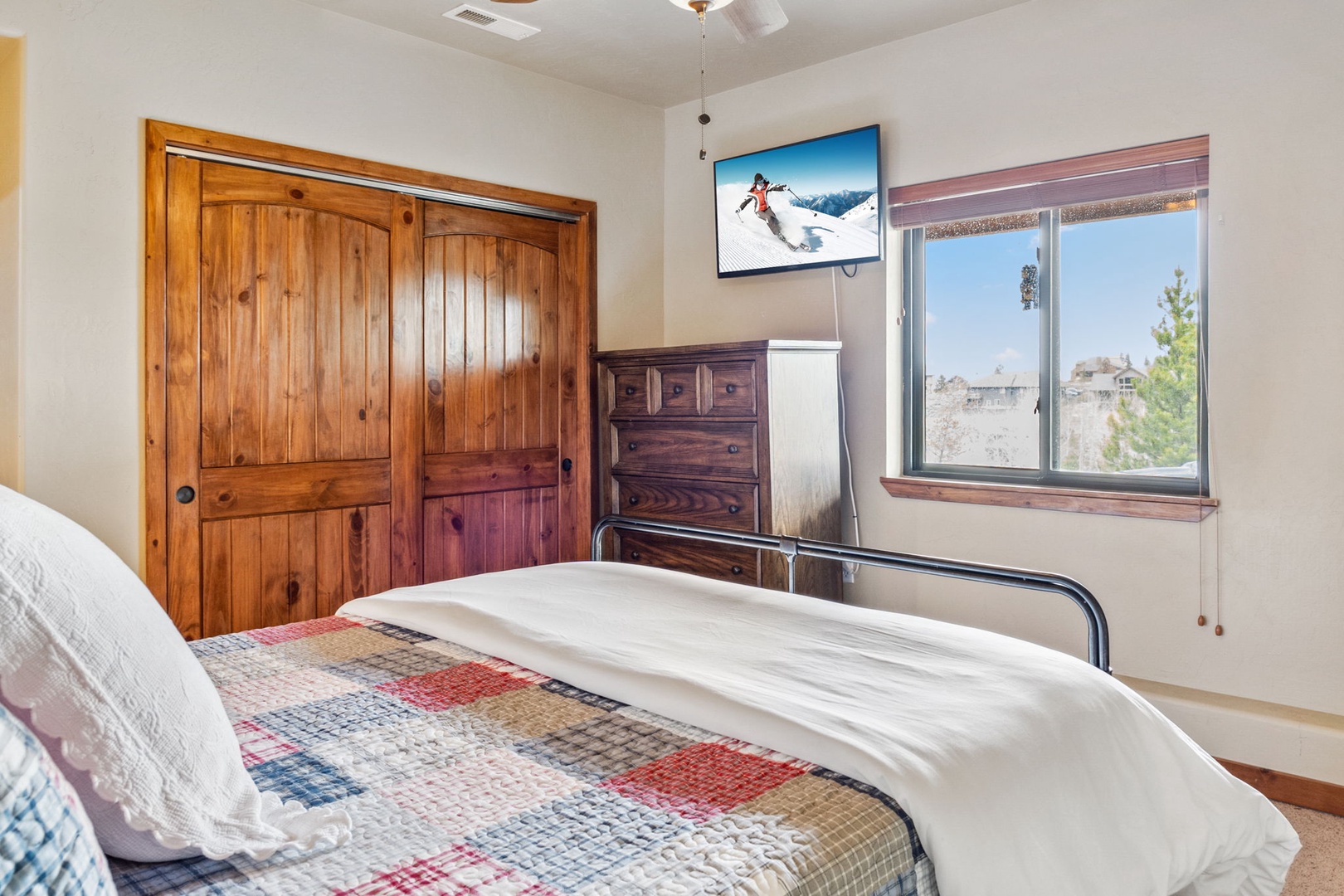 The final bedroom showcases a comfy queen bed & smart TV