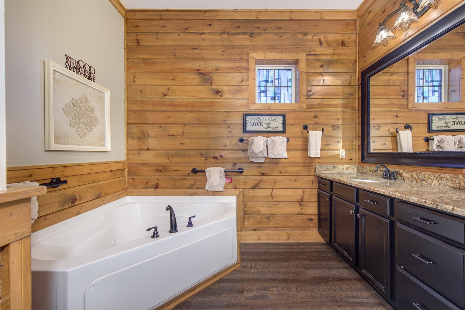 This ensuite offers an oversized vanity, shower, and luxurious soaking tub