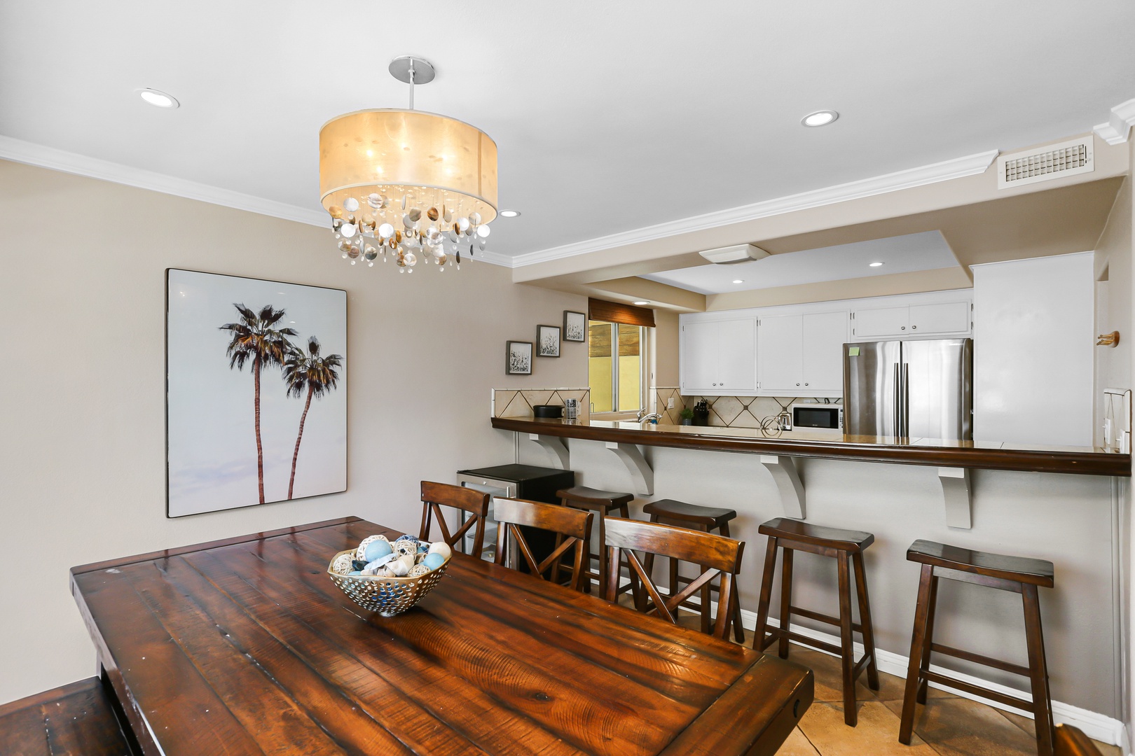 Dining table with seating for 6. Additional bar stool seating for 4 around the kitchen