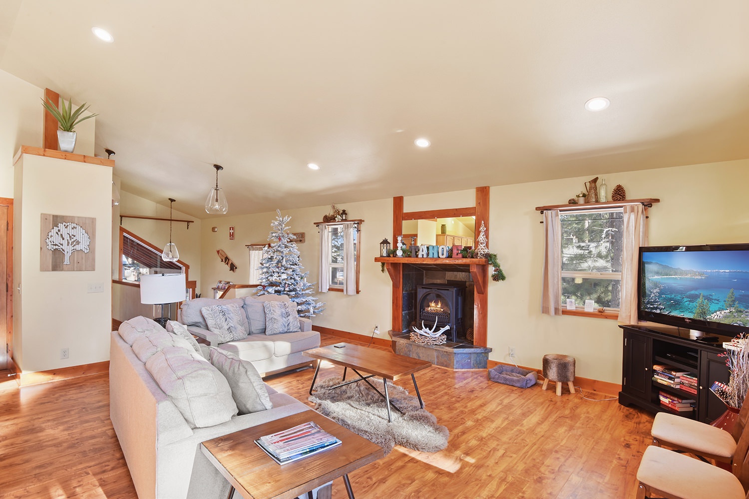 Open living space with gas fireplace, TV, and deck