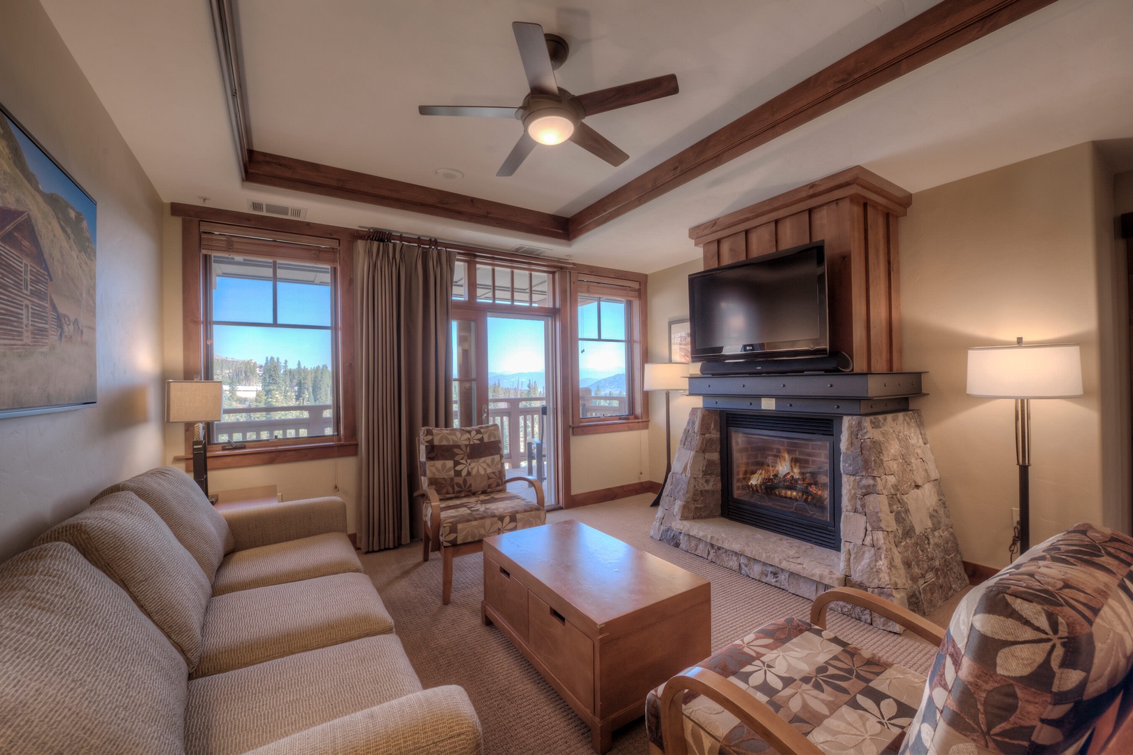 Living room with Smart TV, gas fireplace, balcony access