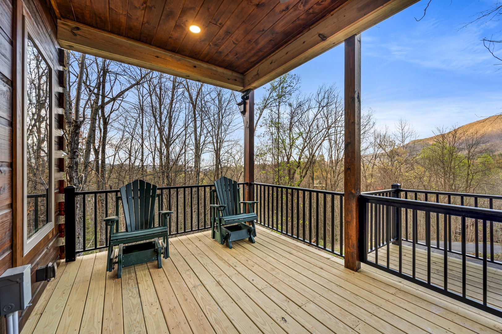 Spacious deck with outdoor seating and hot tub