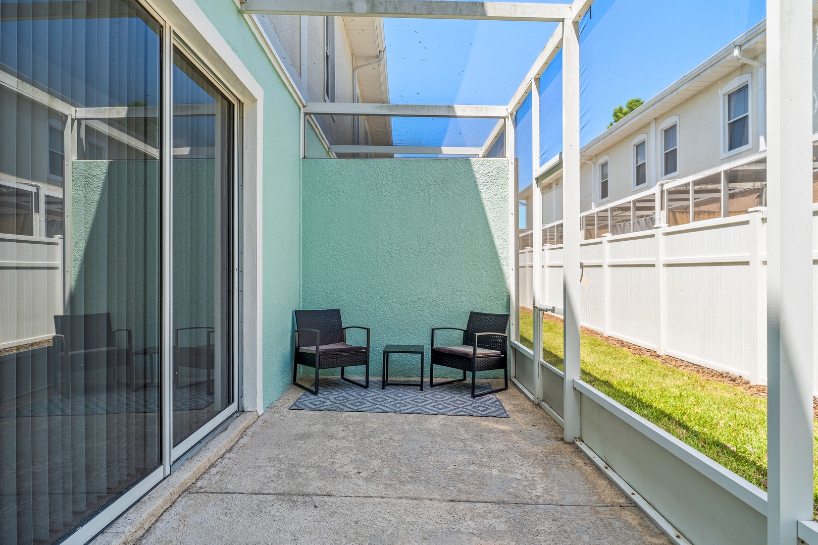 Charming screened-in patio with comfortable seating for two