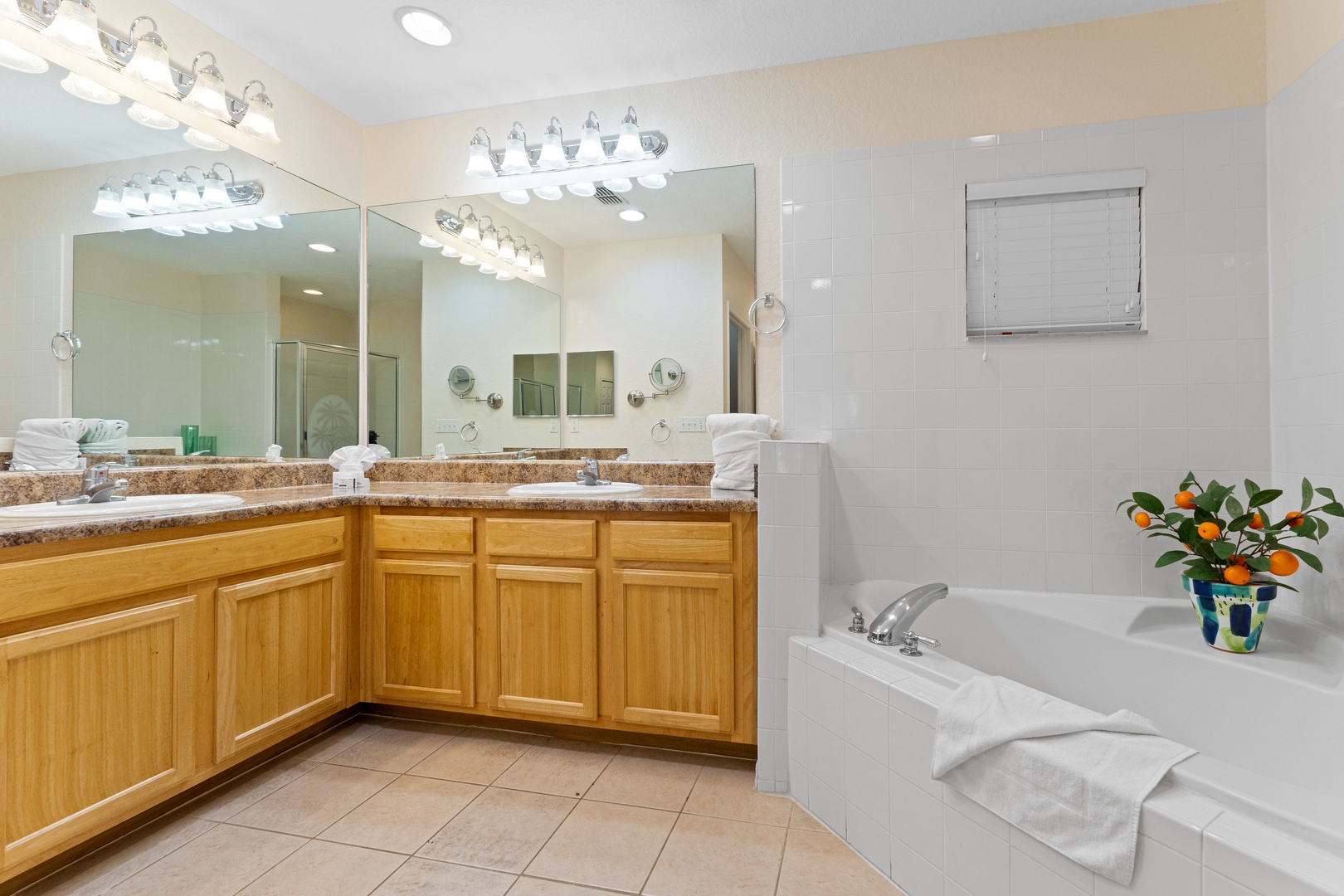 A double vanity, shower, & tub await in the ensuite bath