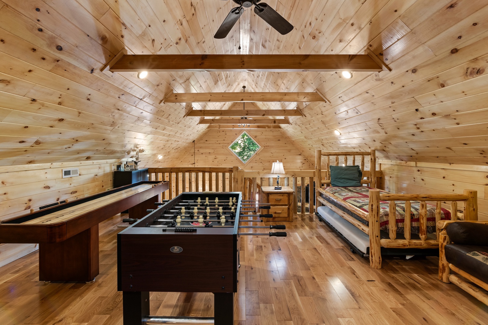 Game & relax in the loft, offering a futon & twin bed/trundle combo