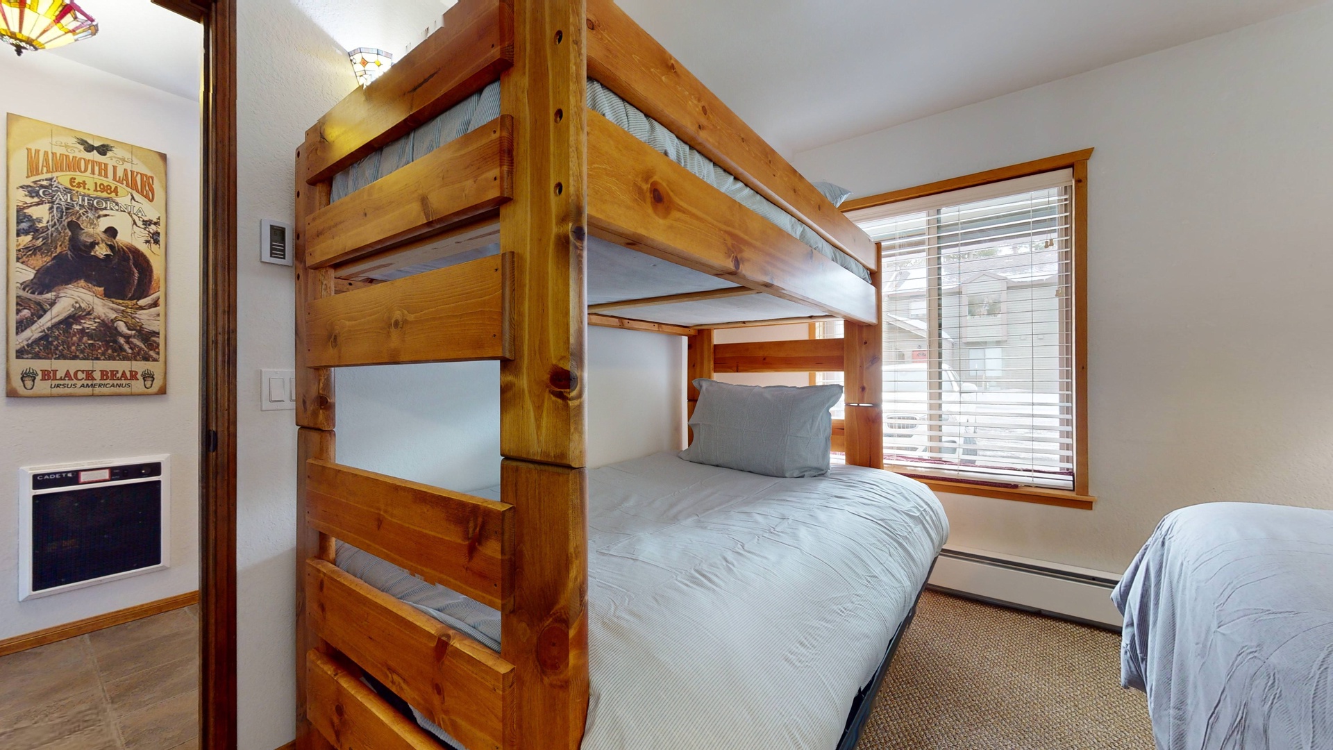 Bedroom 1 with twin/full futon bunk bed, queen bed, Smart TV, and ensuite bathroom