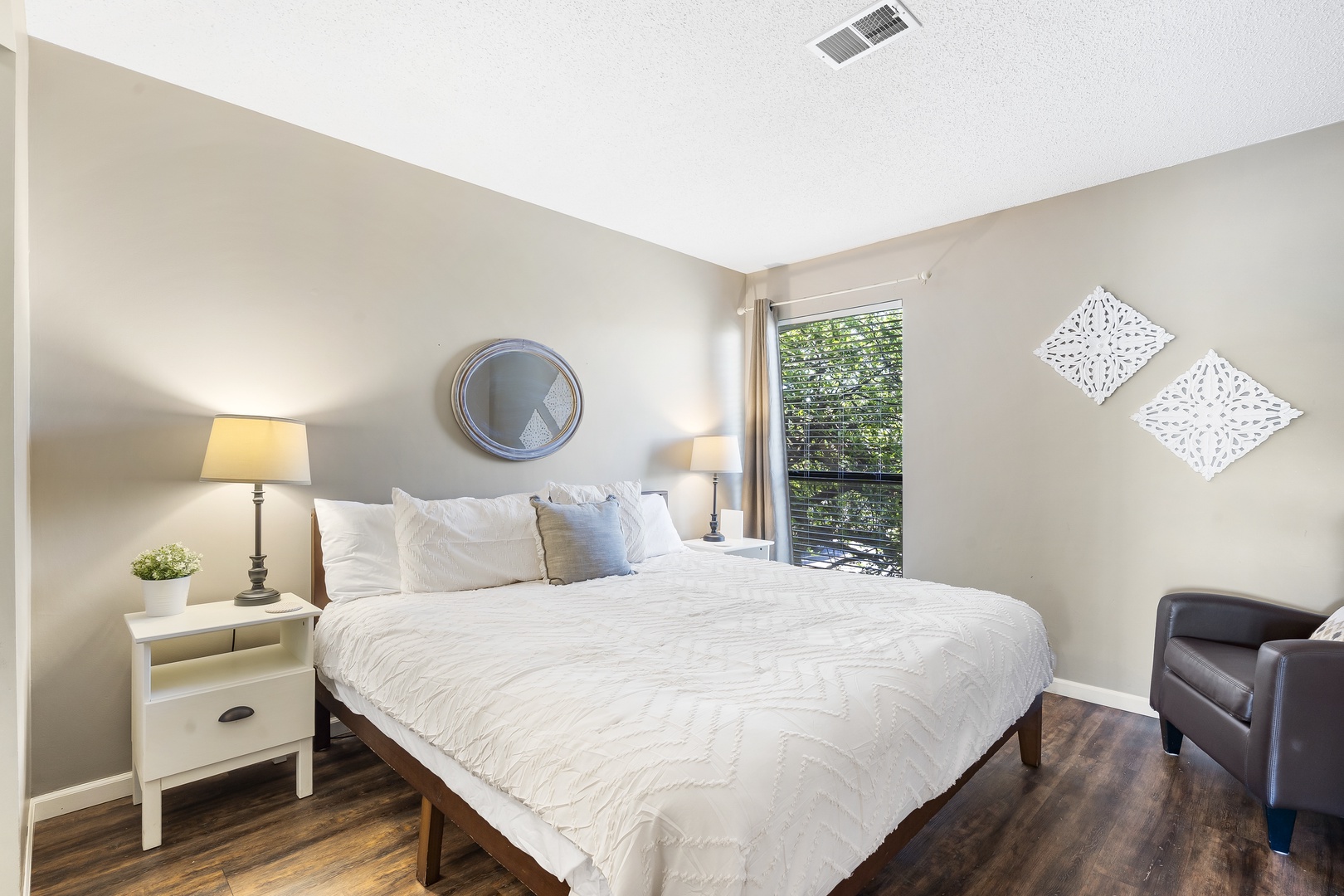 The master suite in Unit 20 boasts a plush king-sized bed, ensuite, & TV