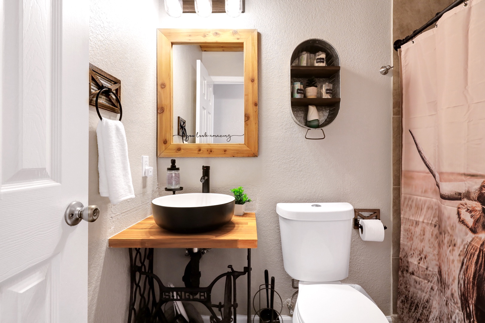 The 1st of 2 full bathrooms offers a stylish vanity & shower/tub combo