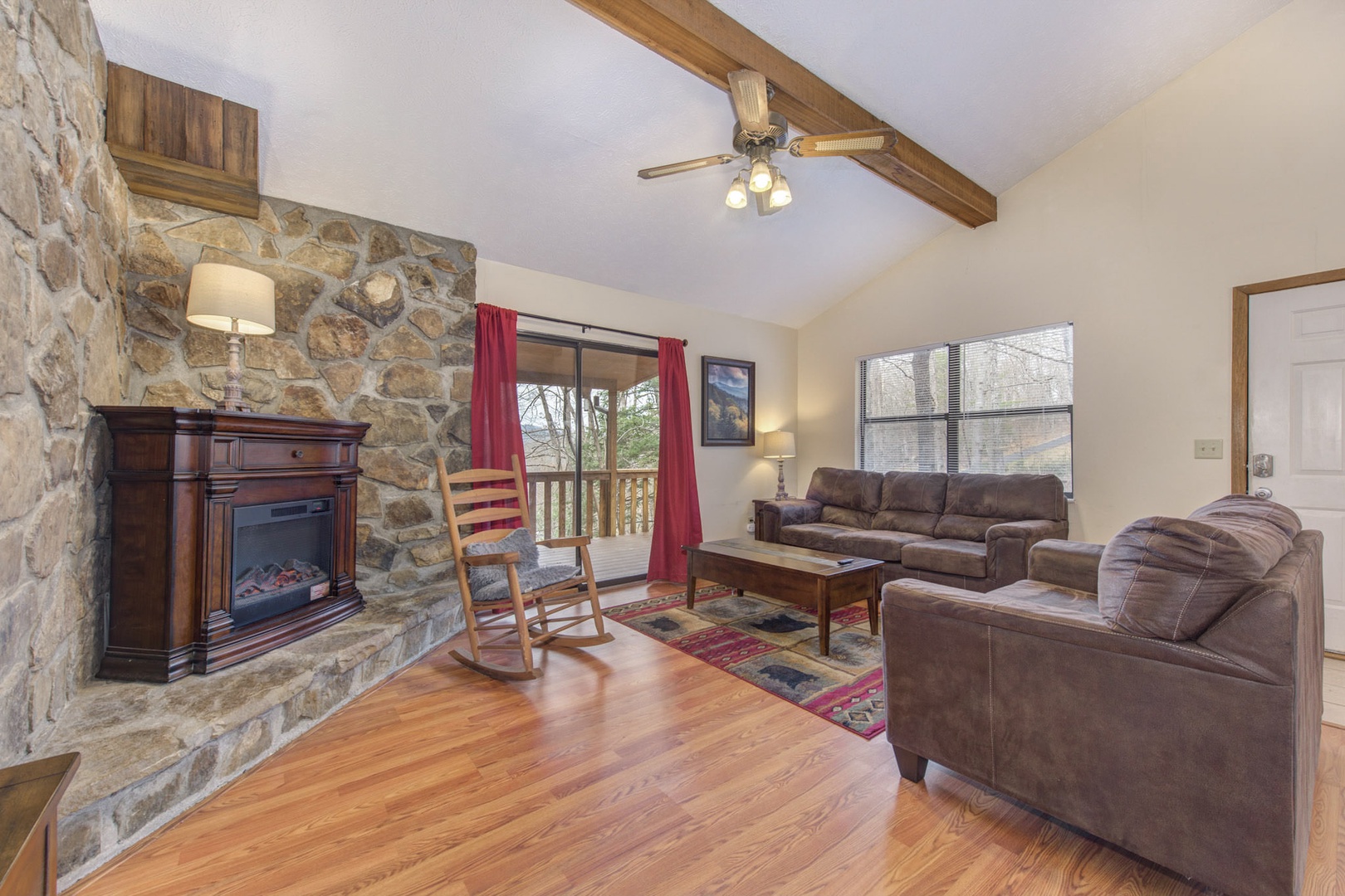 Cozy and spacious living area with TV and fireplace