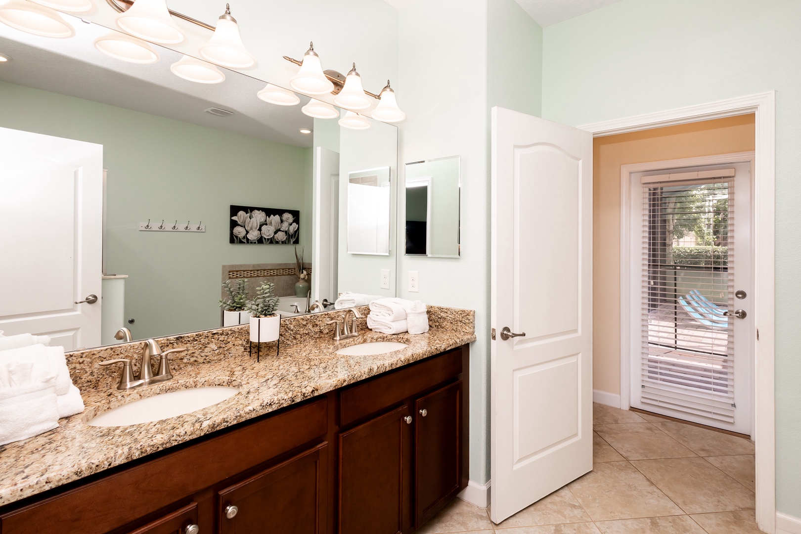 Private ensuite bathroom with dual sinks, separate shower, and soaking tub
