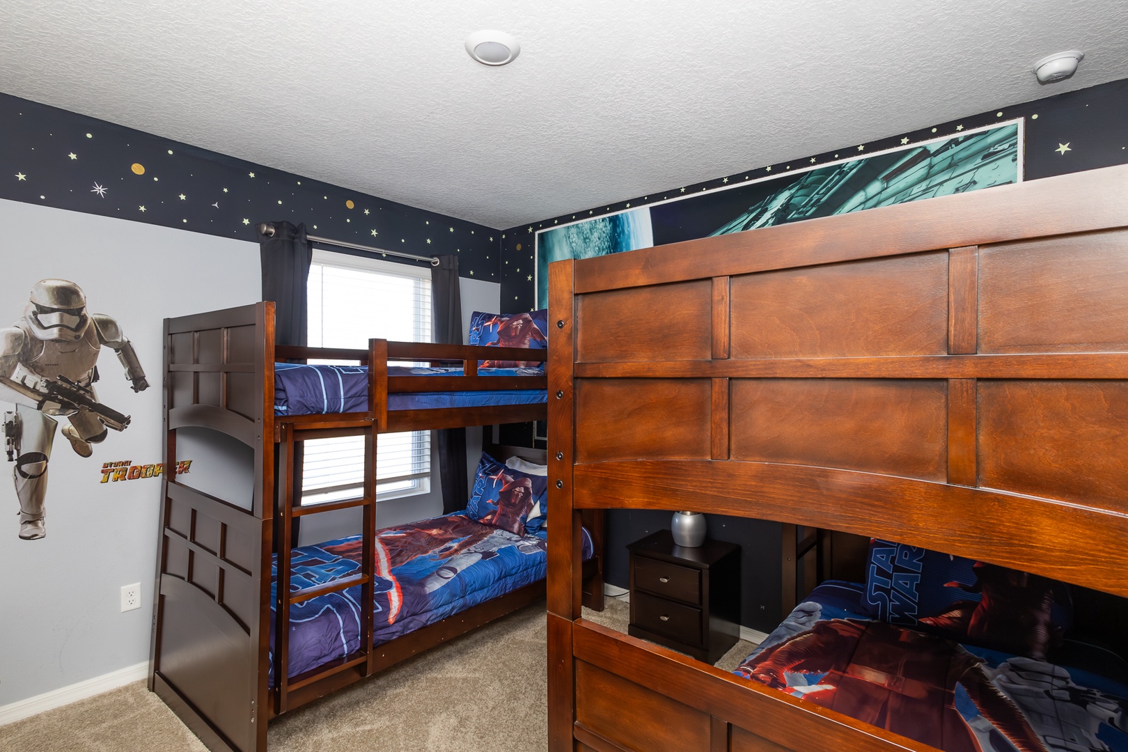 Star Wars-themed bedroom with double twin bunk beds and a smart TV