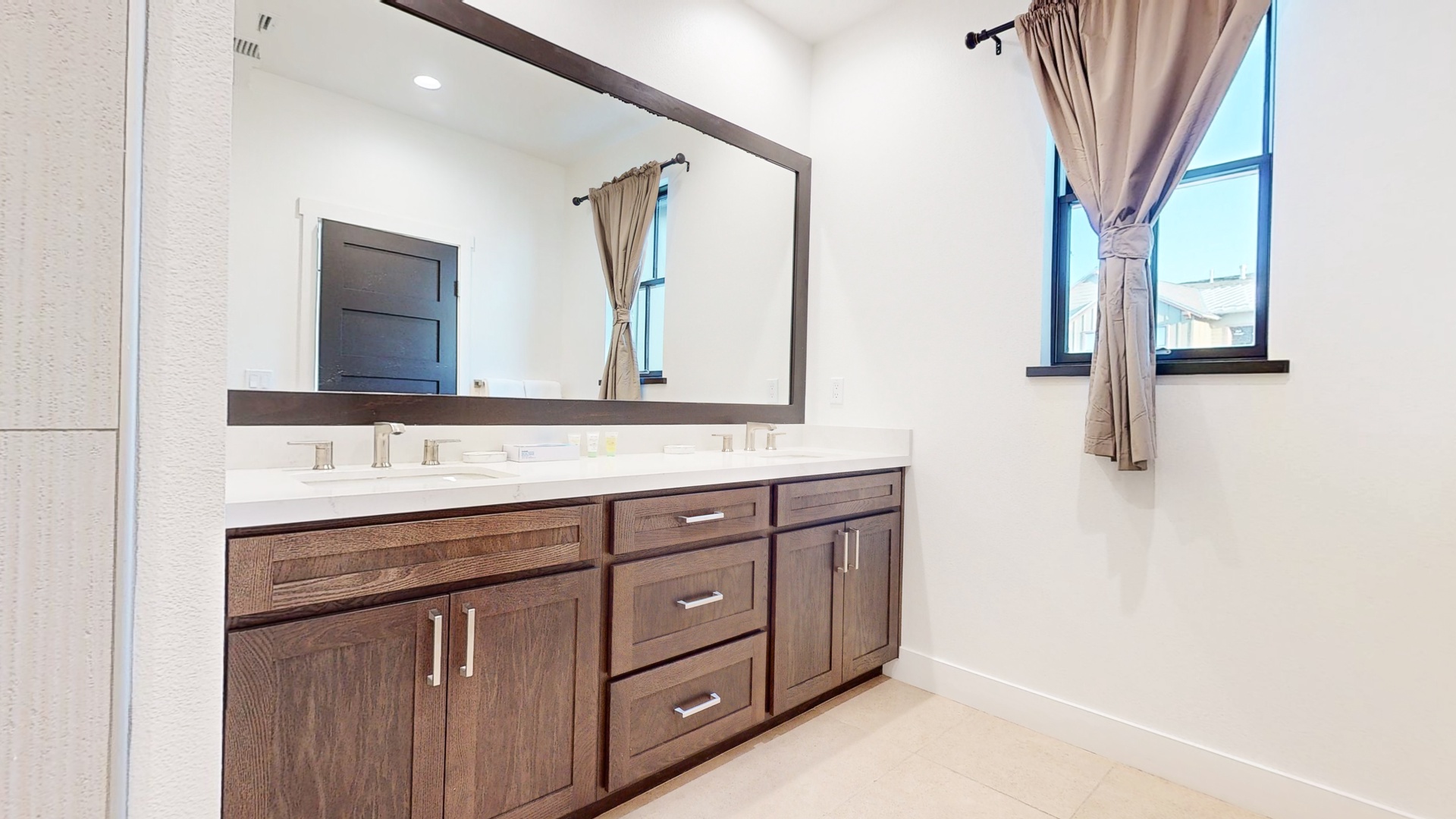 En-suite bathroom with dual sinks, and walk-in shower