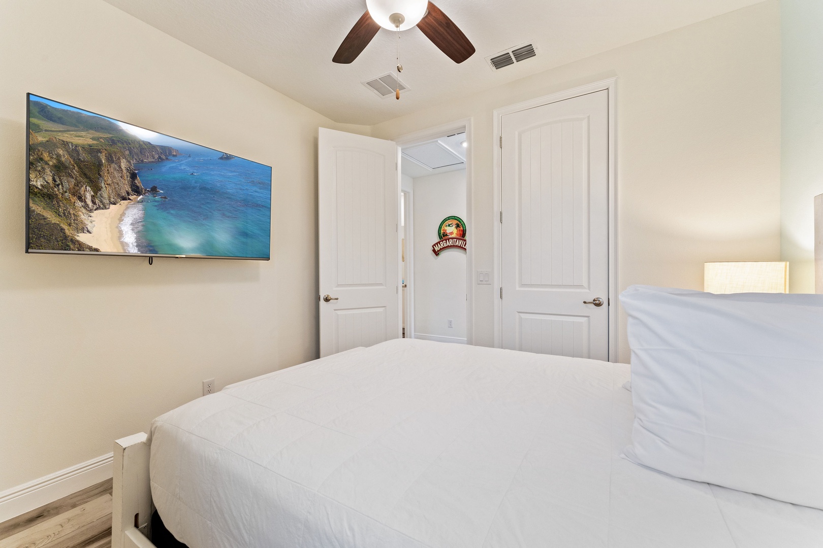 The beachy 2nd floor queen bedroom includes & Smart TV & organized closet