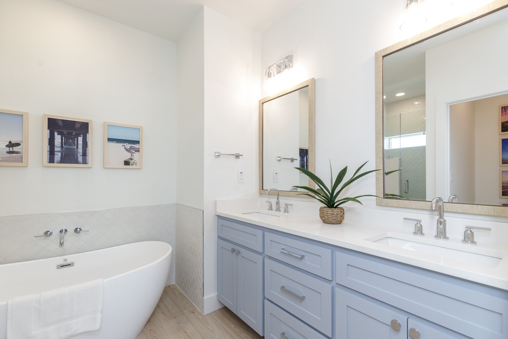 The king en suite bath includes a double vanity, glass shower, & soaking tub