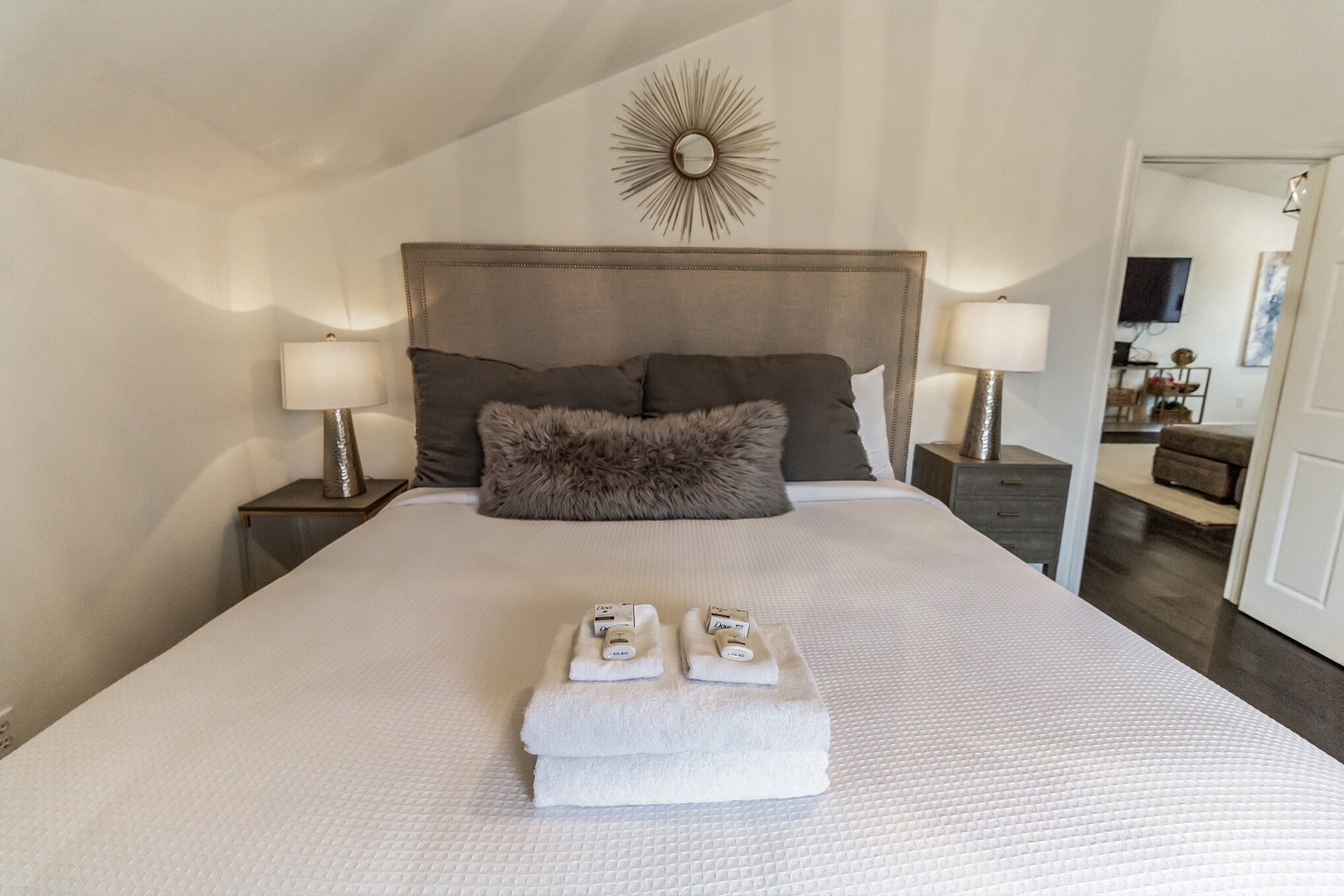 The elegant private bedroom offers a king bed & Smart TV