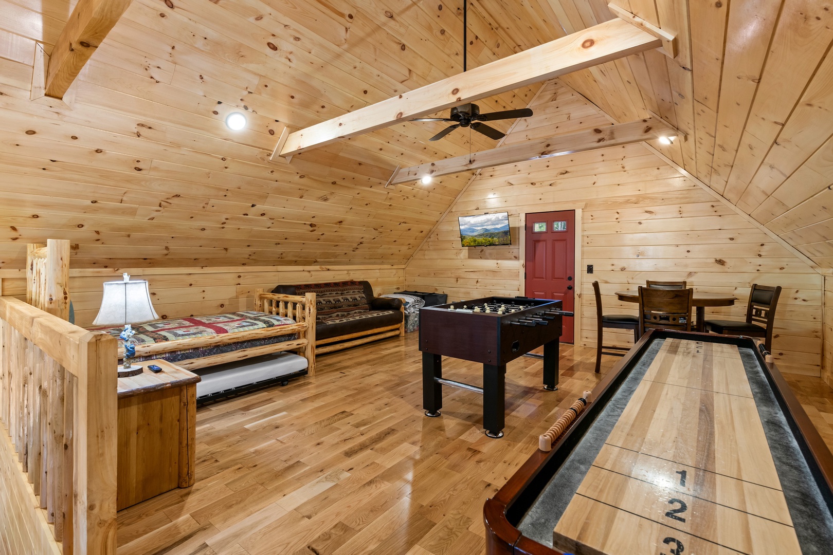 Game & relax in the loft, offering a futon & twin bed/trundle combo