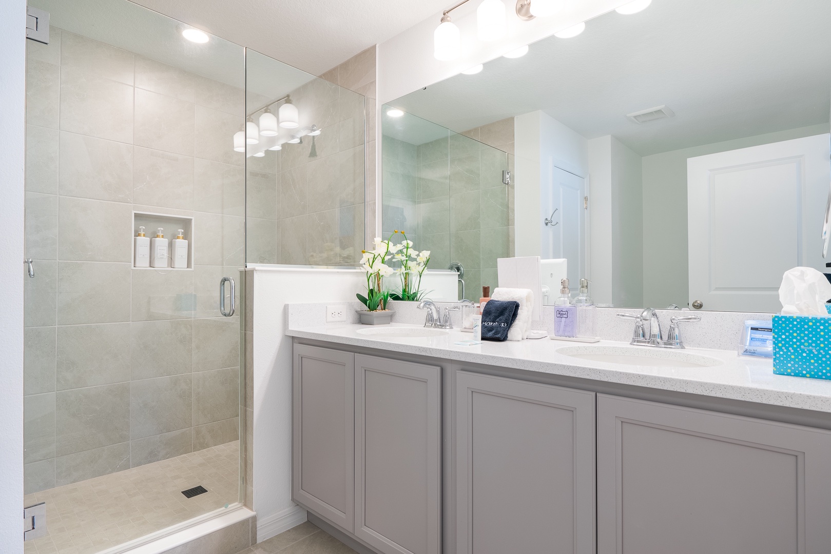 The king en suite bathroom offers an oversized double vanity & glass shower