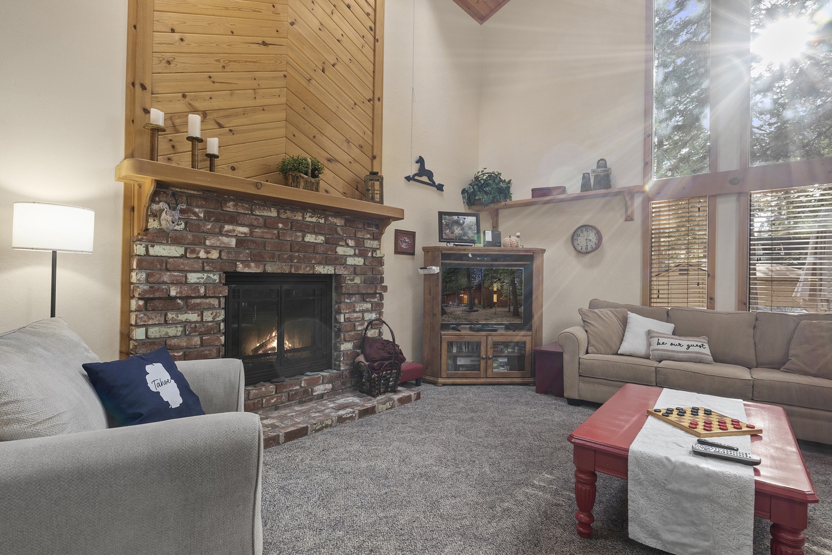 Living room with floor to ceiling windows, gas fireplace, RokuTV