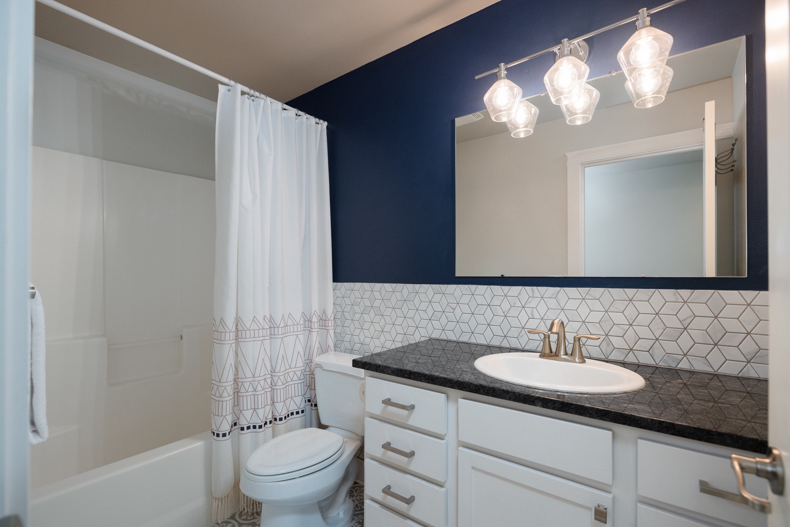 A second full bathroom offers a single vanity & shower/tub combo