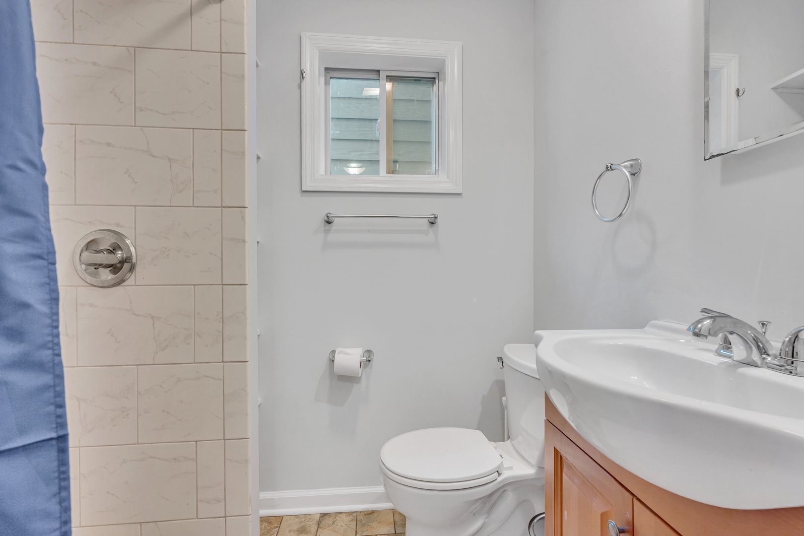 Unit 1’s full bathroom offers a single vanity & shower