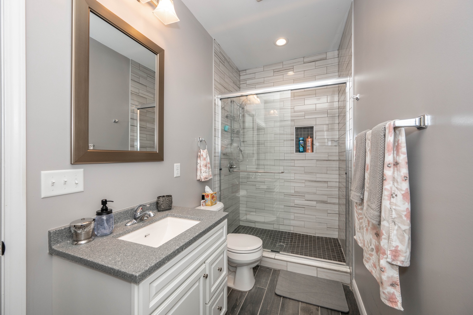 Enjoy a single vanity & glass shower in the ensuite bathroom