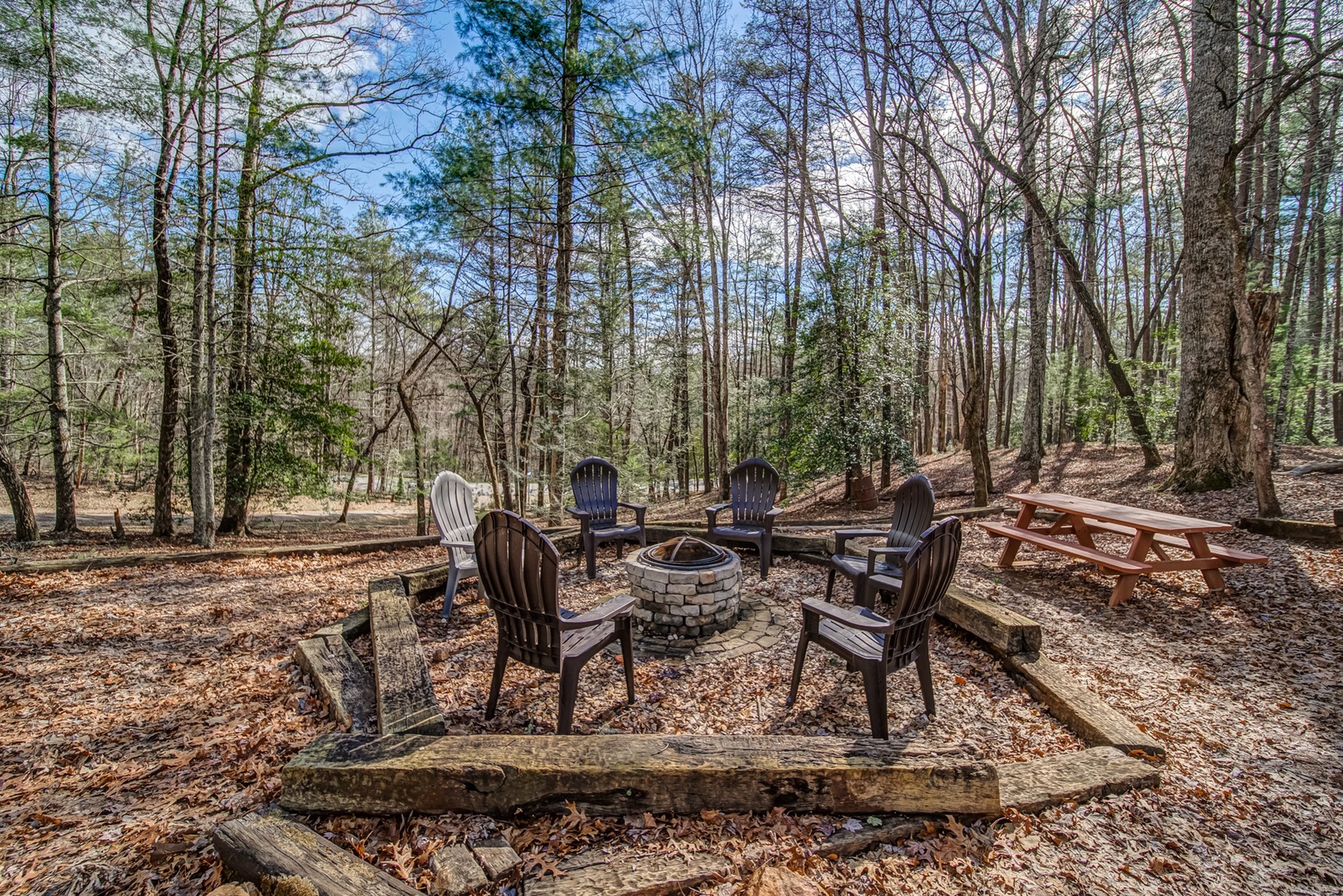 A casual stroll down the gravel path takes you to this extra large firepit area with picnic table for roasting marshmallows and swapping stories