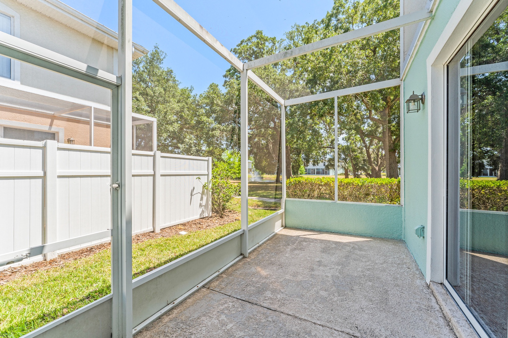 Charming screened-in patio with comfortable seating for two