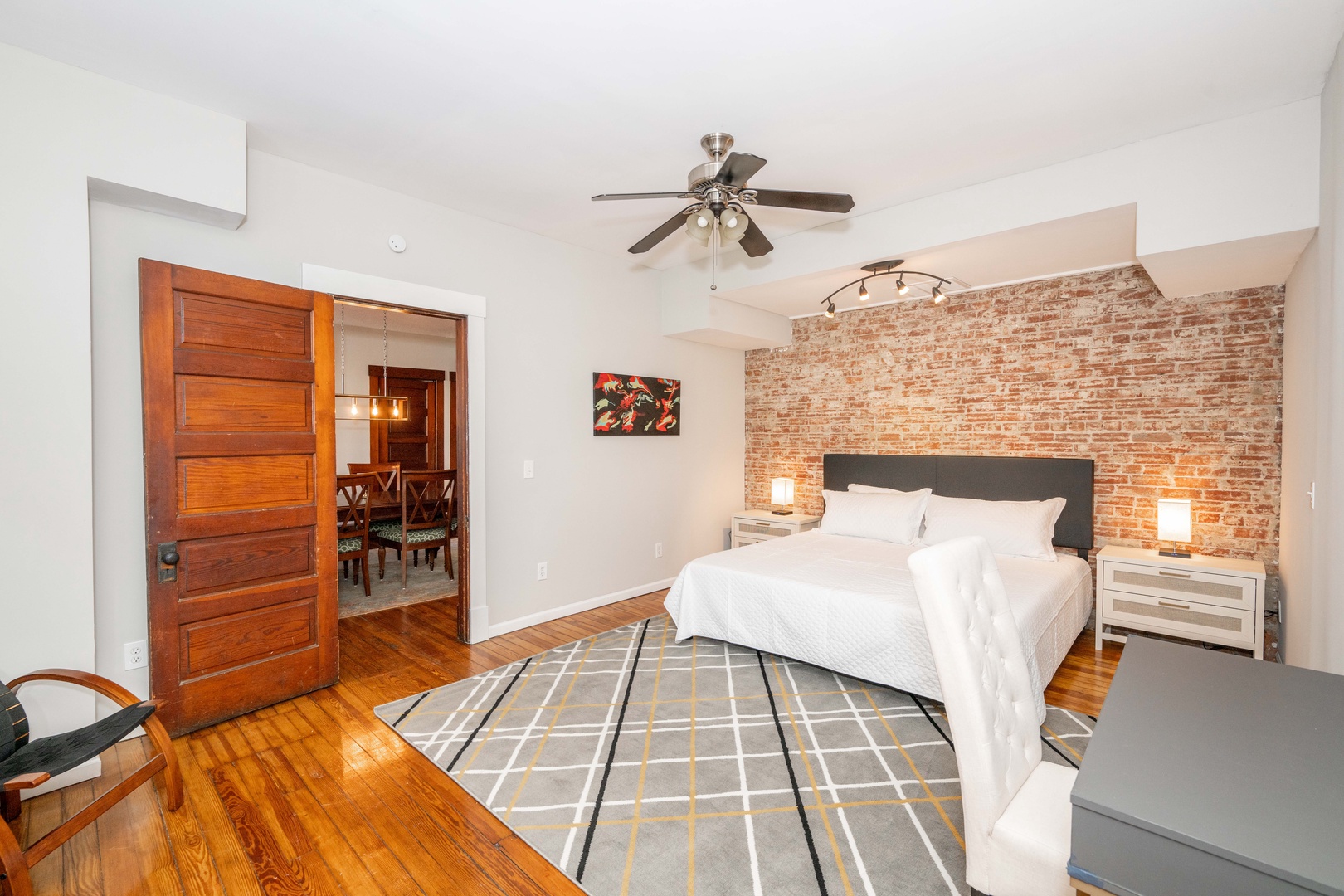 This spacious bedroom features a king-sized bed, Smart TV, & desk workspace