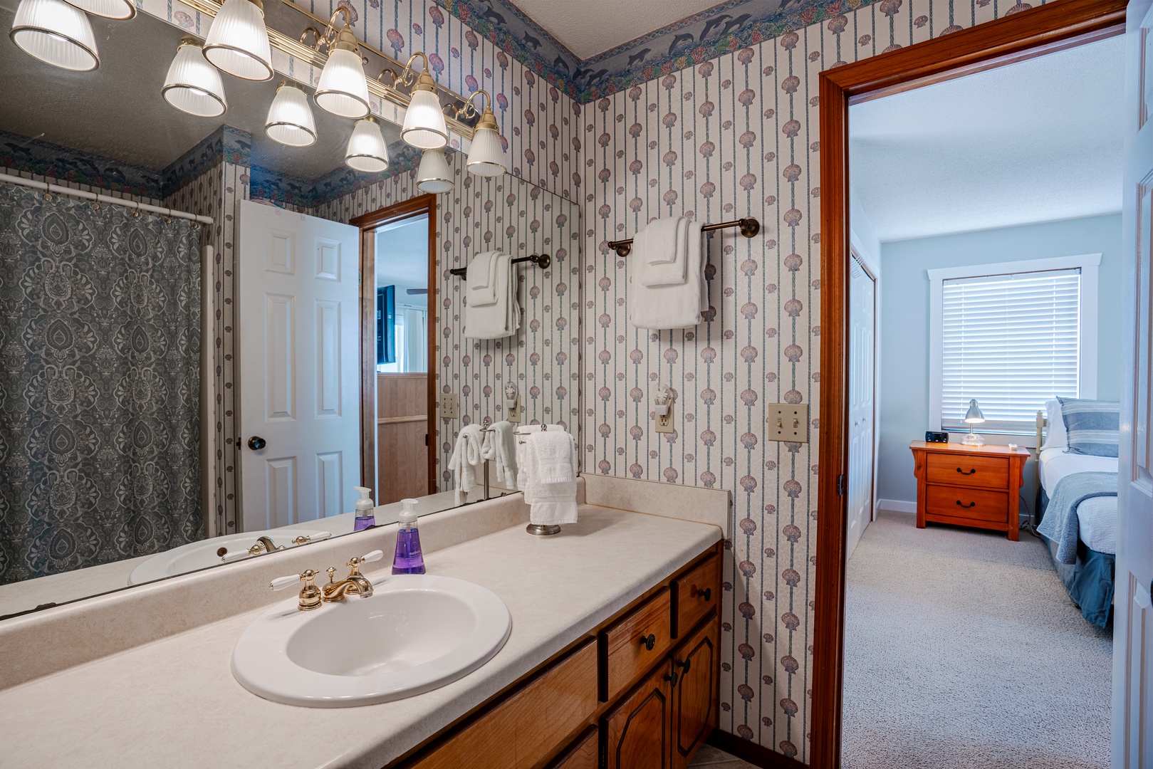 The first ensuite boasts a single vanity & shower/tub combo