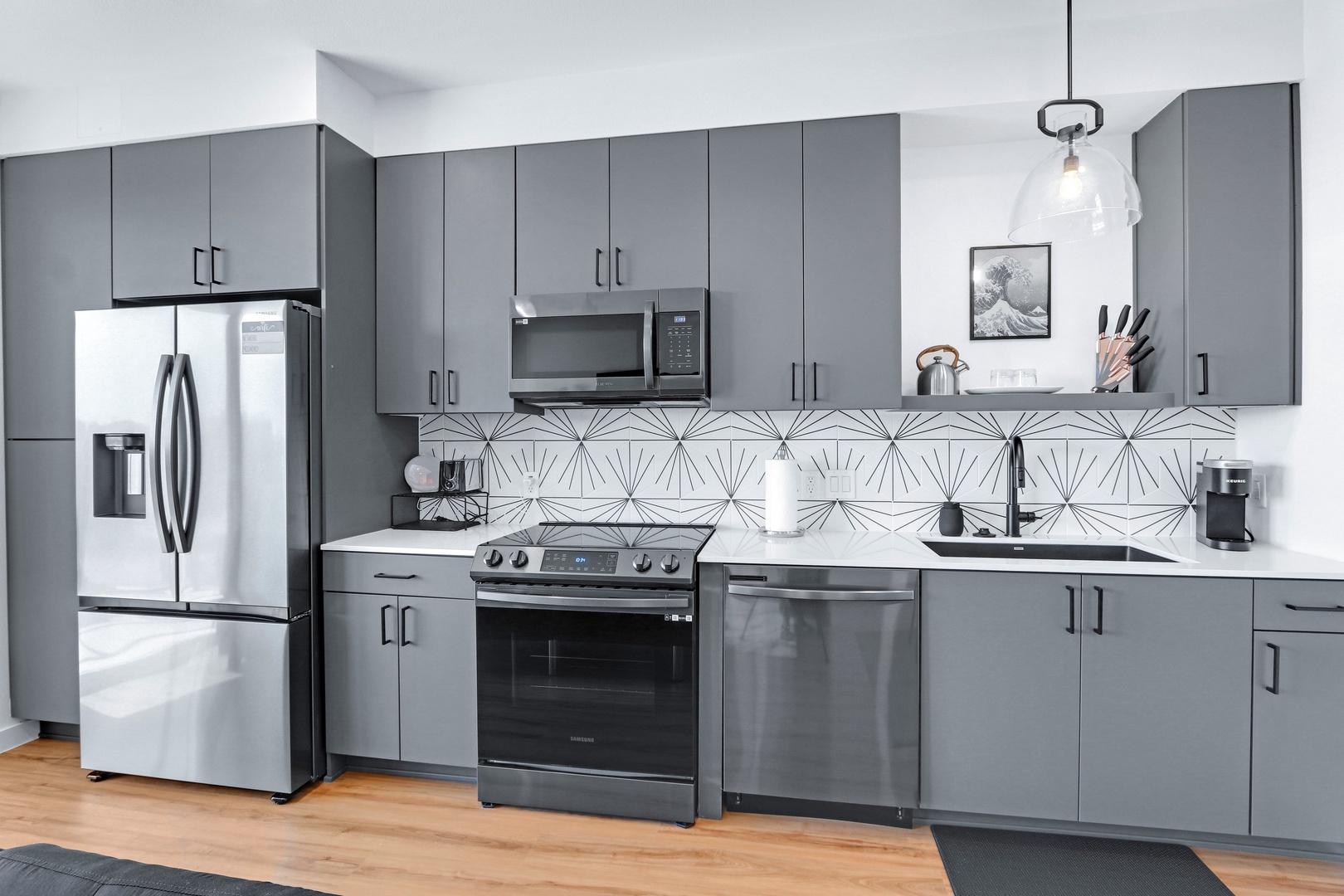 The sleek, updated kitchen offers ample space & every home comfort