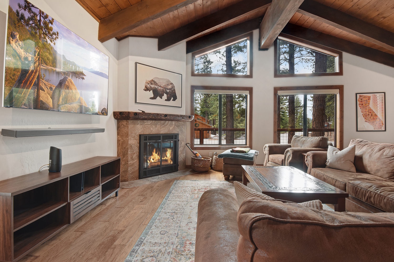 Open living space with TV, fireplace, and deck access