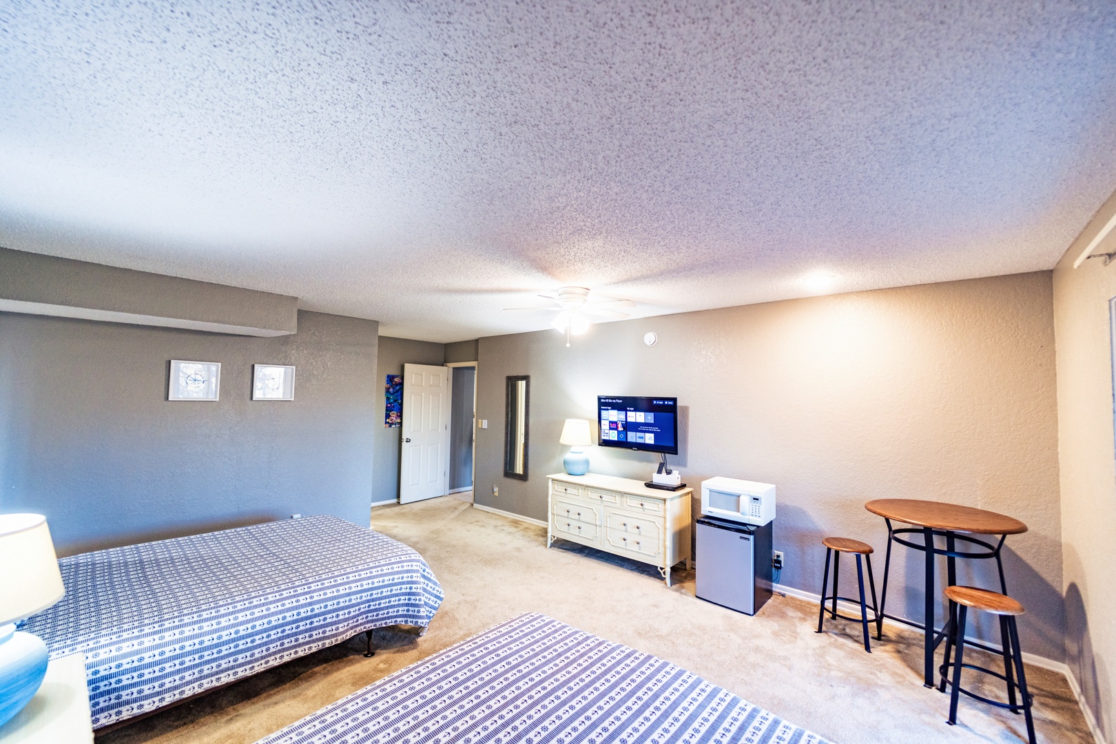 This lower-level suite offers a pair of queen beds, ensuite, Smart TV, & deck access