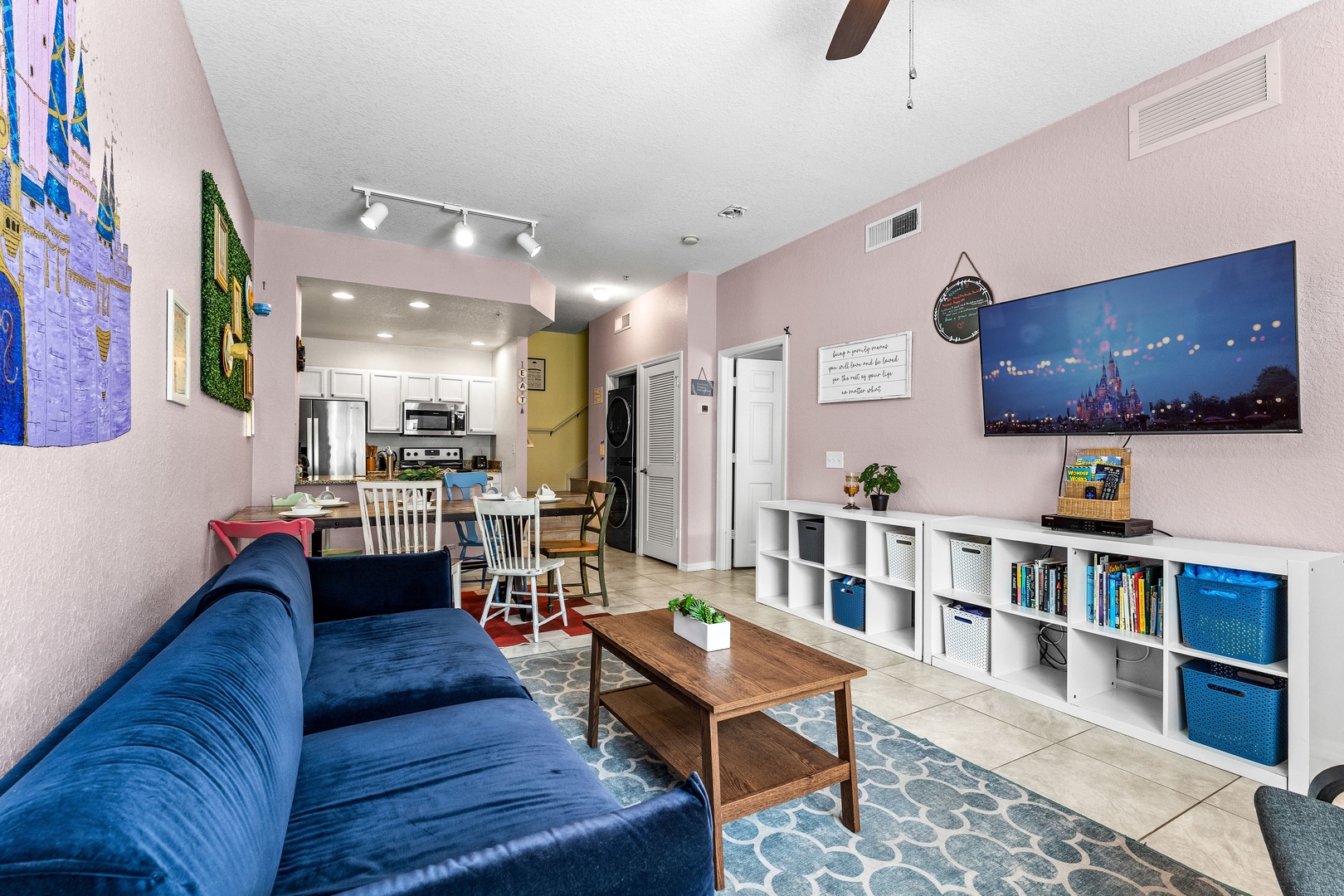 Cozy and spacious living area with, ceiling fan & smart TV