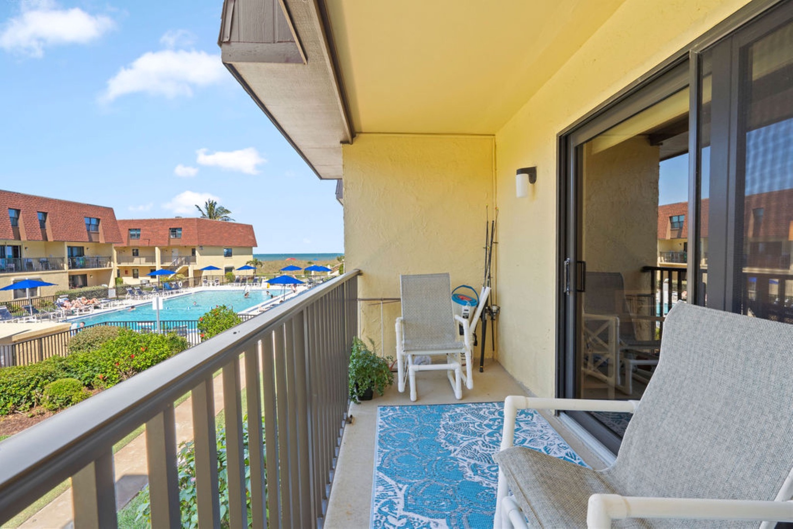 Private balcony with outdoor seating and pool views