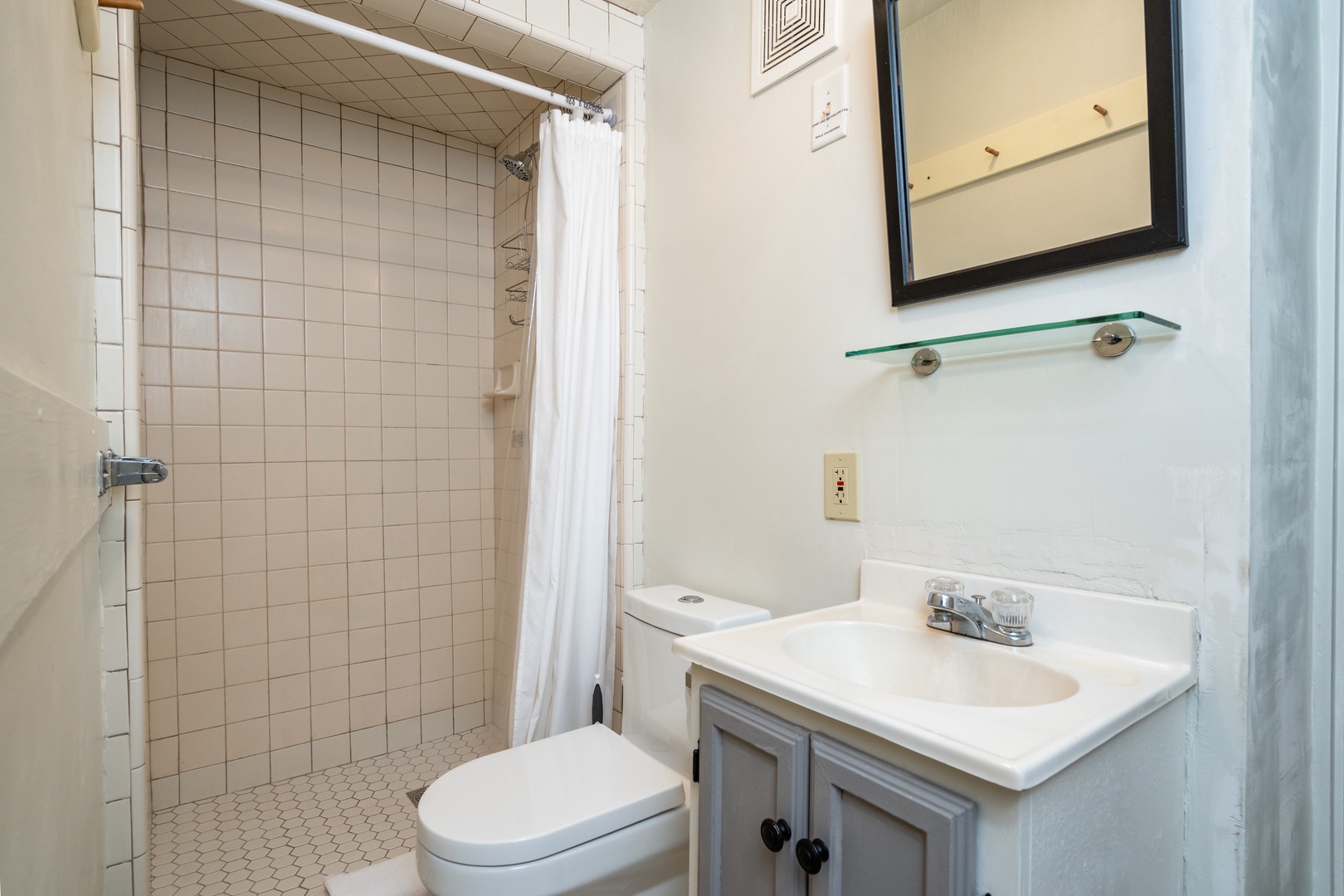 The full bathroom features a single vanity & walk-in shower