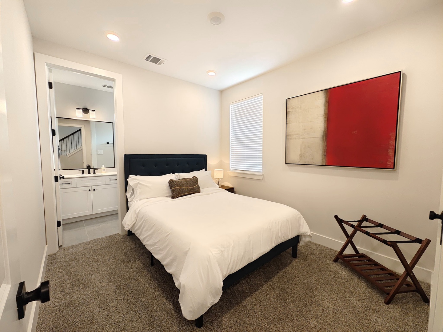 The 1st-floor suite features a plush queen bed & private ensuite