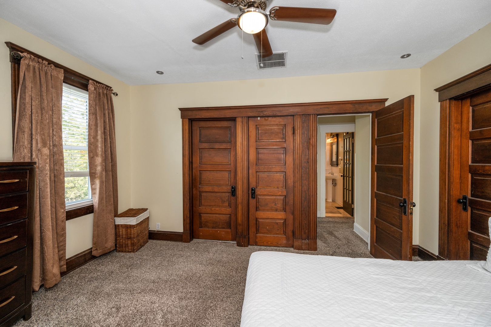 The 2nd of 2 queen bedrooms on the second level, with a dresser & ceiling fan