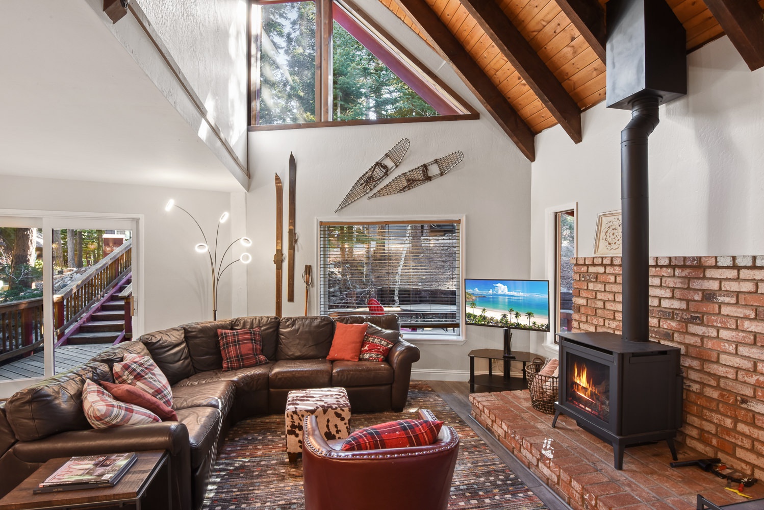 Open living space with fireplace, Smart TV, and deck access