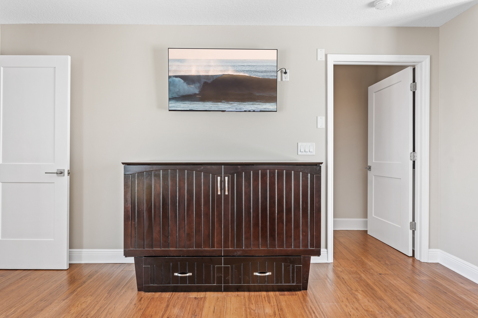 The queen murphy bed in the game room